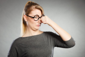 woman holding her nose closed due to bad oder