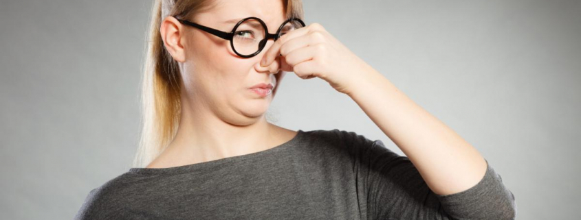 woman holding her nose closed due to bad oder