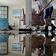Man cleaning flooded home