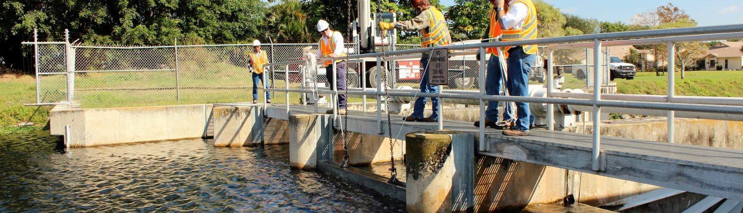 Men working at water control structure