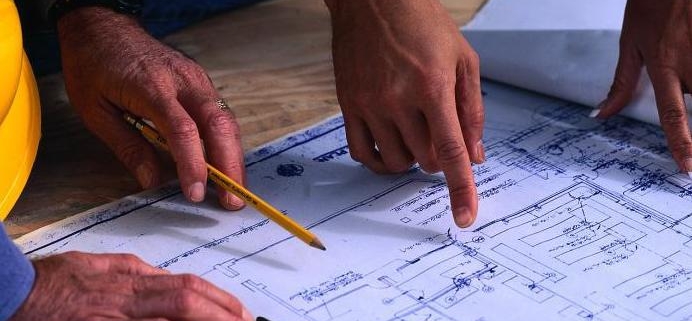 Men looking a set of blueprints