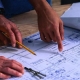 Men looking a set of blueprints