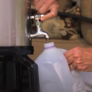 Person filling jug with used cooking oil