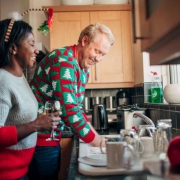 man and woman washing dishes