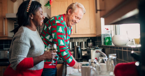 man and woman washing dishes