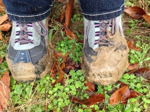 person standing in muddy grassed area