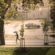 man with umbrella walking in rain storm