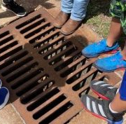 standing around a street drain