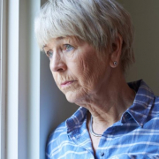 Older woman looking out the window