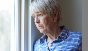 Older woman looking out the window