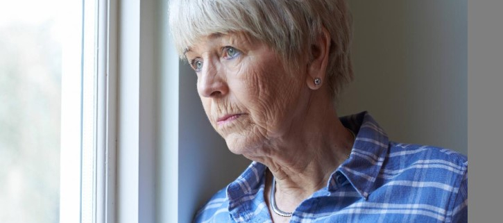 Older woman looking out the window