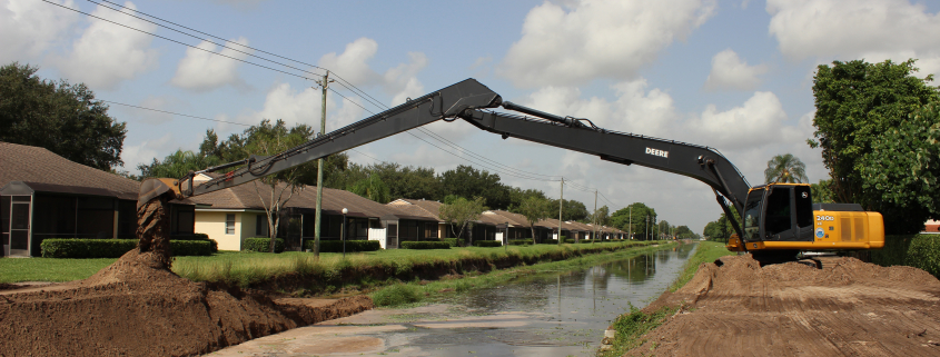 Equipment building the bank on a canal