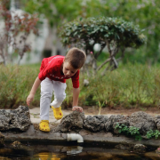 Small boy playing near a water body