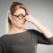 woman holding her nose closed due to bad oder